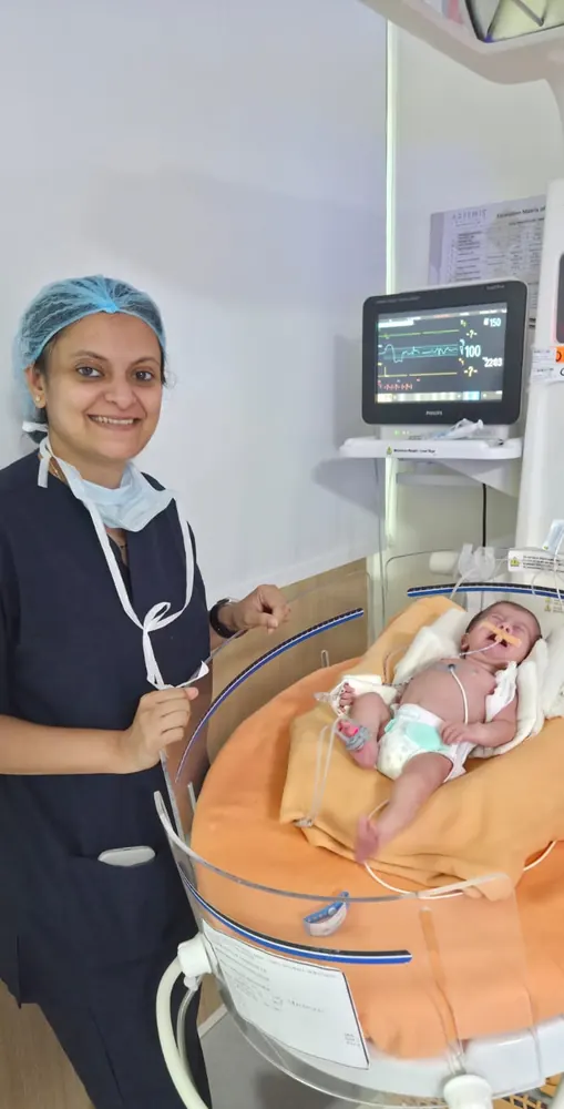 Dr. Trisha Srivastava with a newborn patient in the neonatal unit